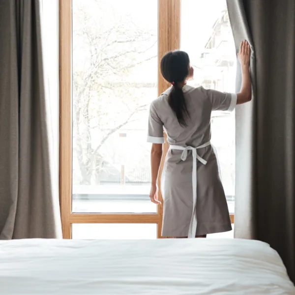 Housekeeper arranging folded towels in a hotel room